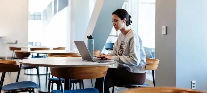 woman working on laptop while sitting at table