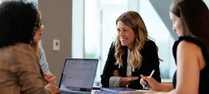 Manager's brainstorm around table.