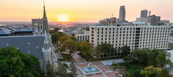 Morning skyline of Creighton campus with warm sunrise.