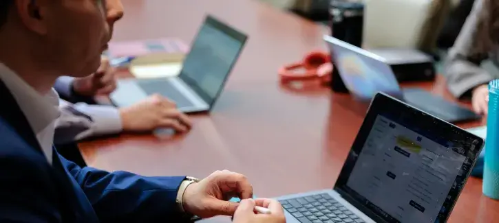 People studying together in conference room setting.