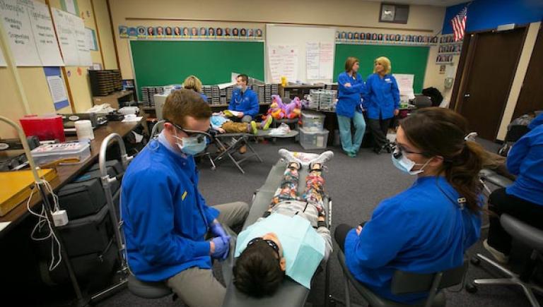Creighton dental students working on children at local facility.