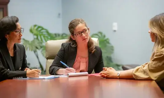Students with mentor at table.