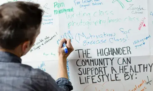 Student writing on white board.