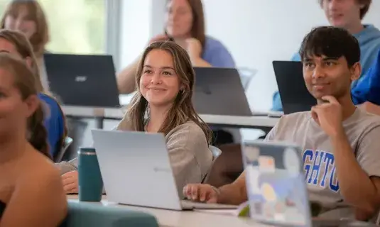 Students smiling in class.