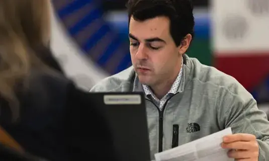 Studying tax return in office setting.