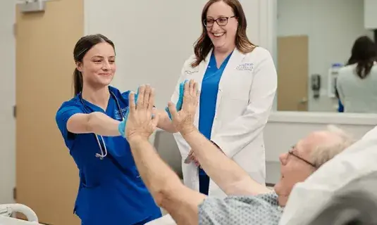 Nurse high fiving patient