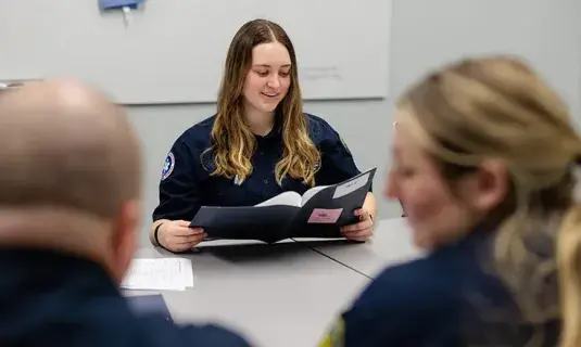 EMS workers talking at table.
