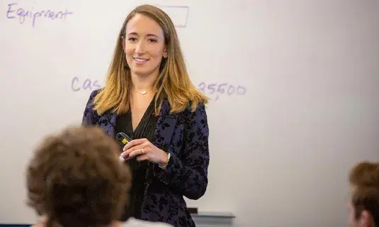 accounting professor at whiteboard