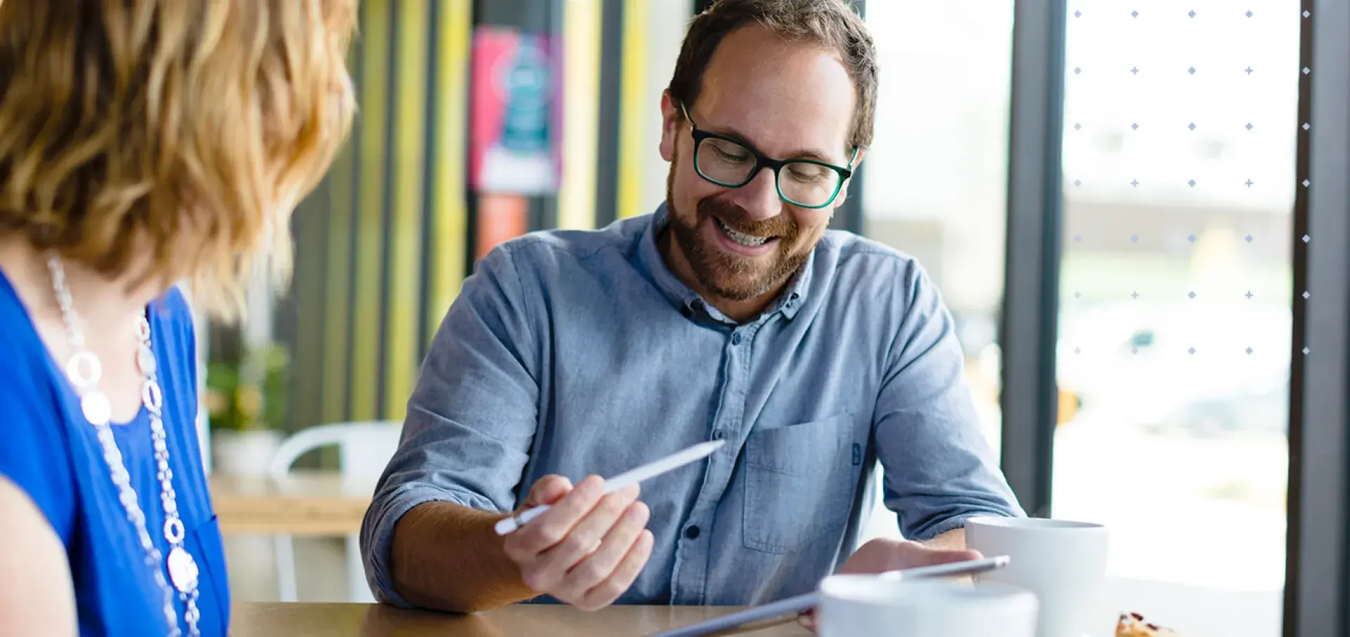 Man and woman studying options around a table in their home