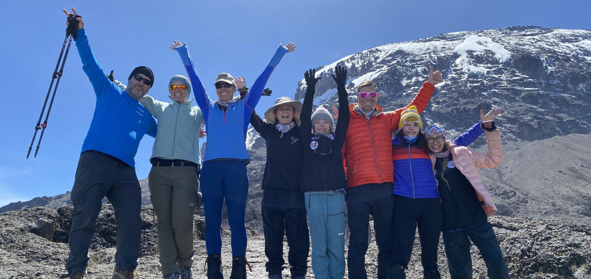 eight burn survivors with top of kilimanjaro 