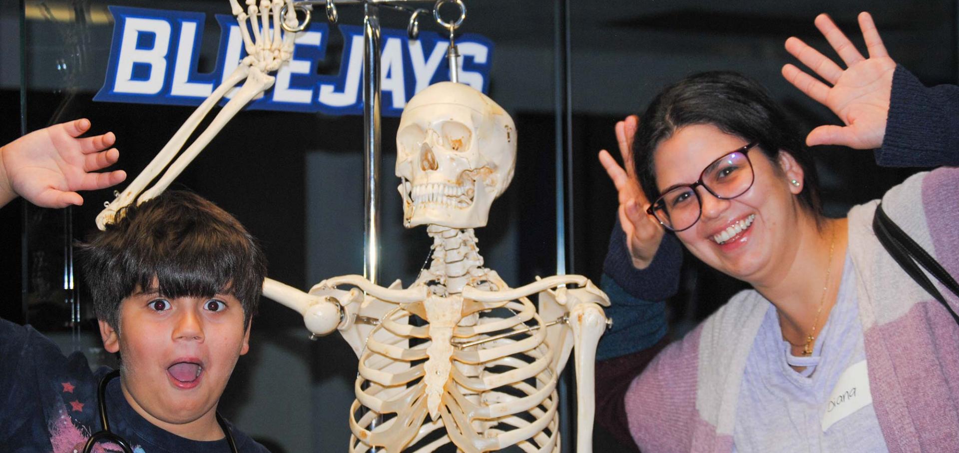 student and mom waving with waving skeleton