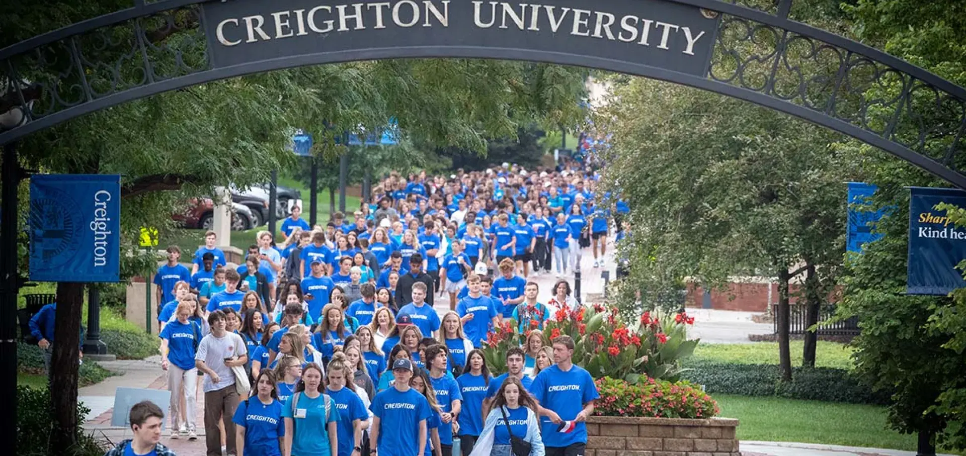 The new freshmen class passes under the Creighton archway.
