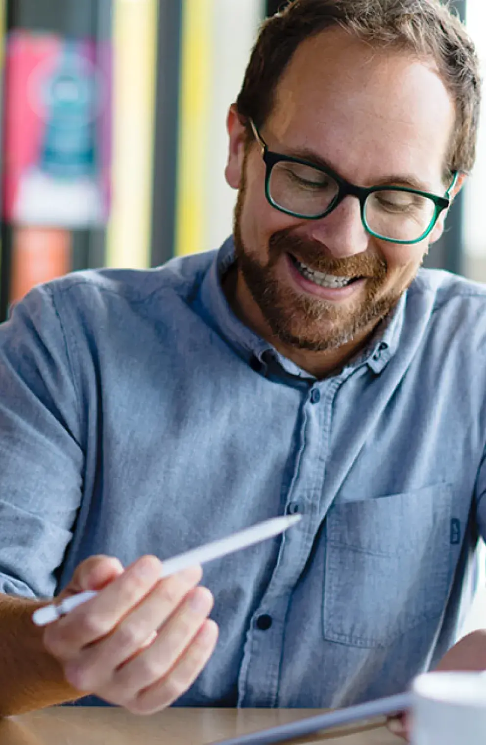 Man and woman studying options around a table in their home