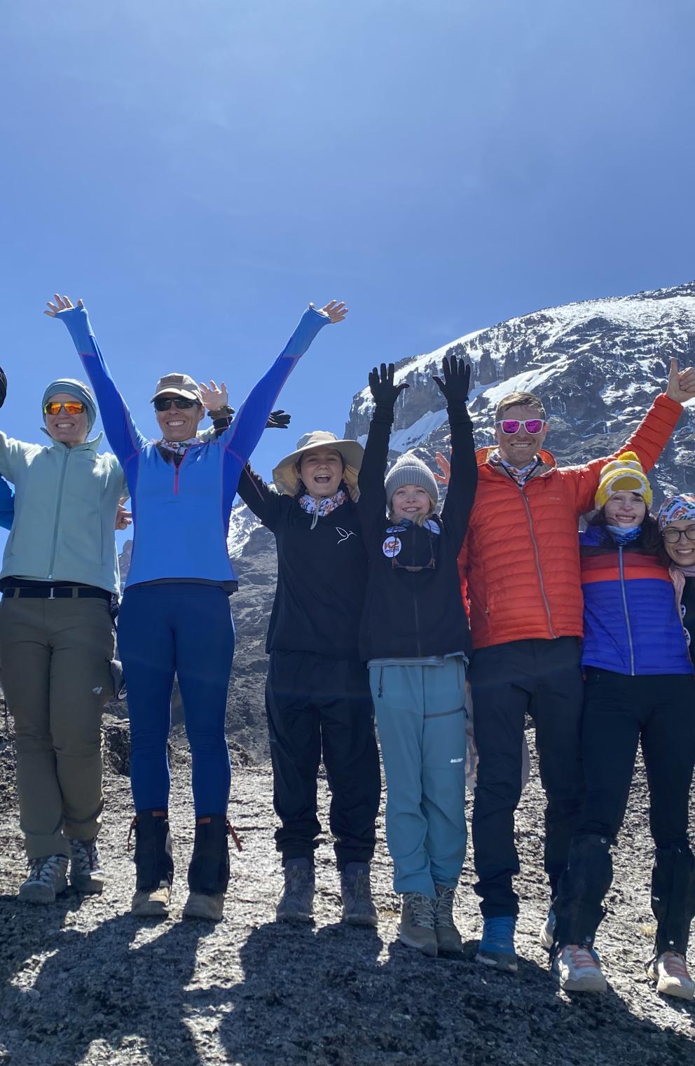 eight burn survivors with top of kilimanjaro 