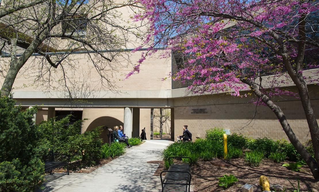 Health Science Library exterior with blossoming tree