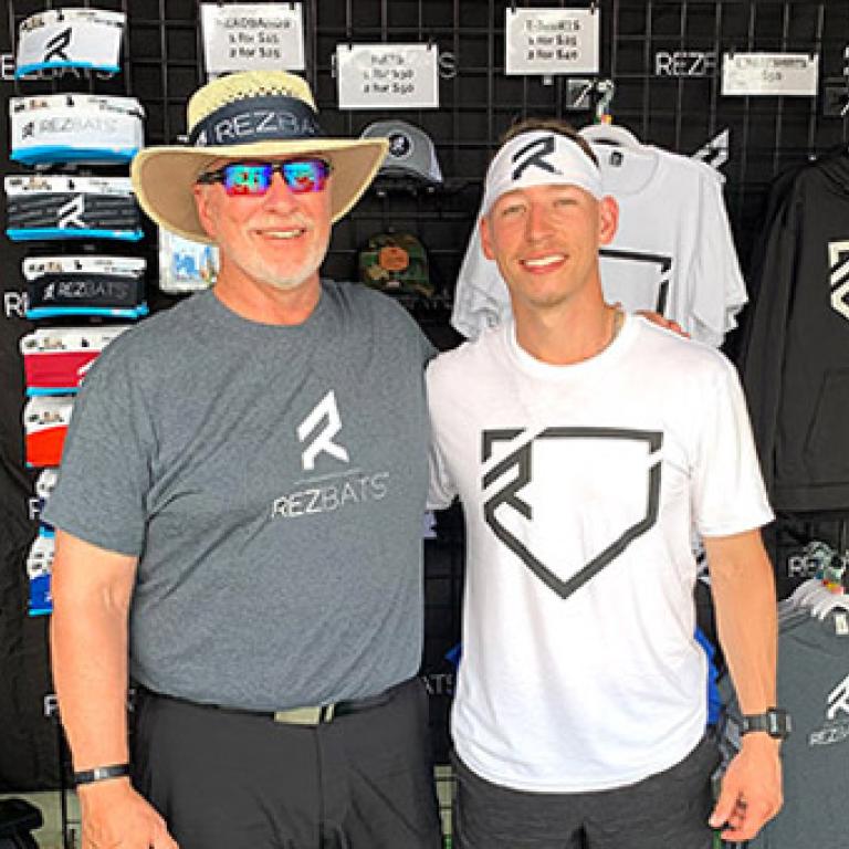 Ben Reznicek with father promoting his bats at the 2021 College World Series.