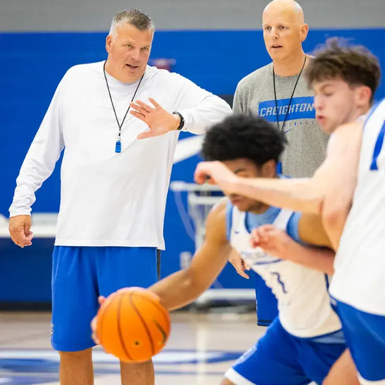Greg McDermott and Alan Huss coaching basketball practice