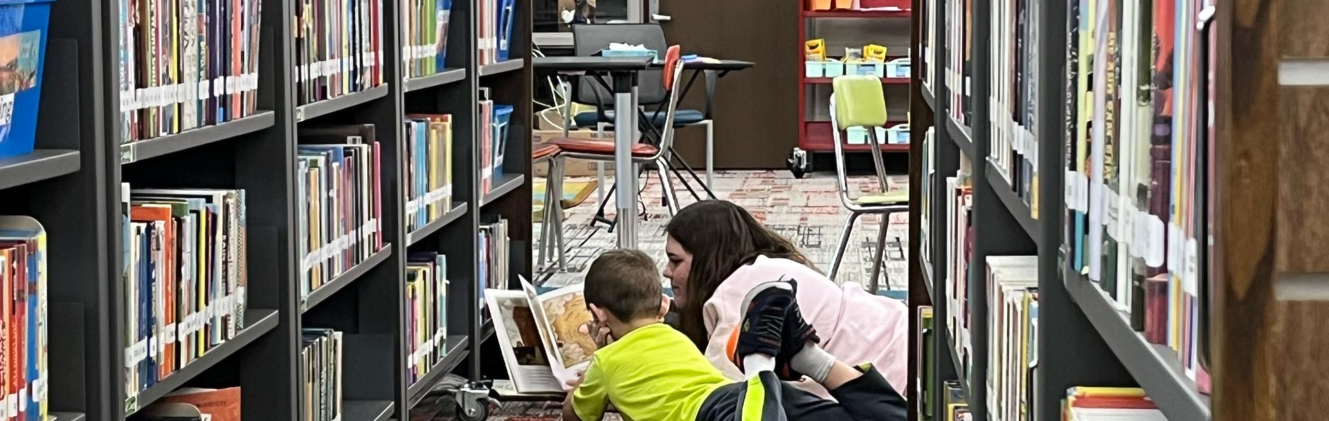 CK Gifford Park volunteer reading with student.