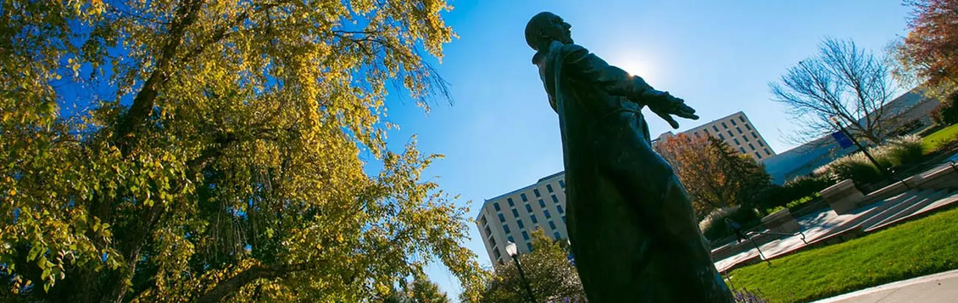 Jesuit statue in early morning sunlight.