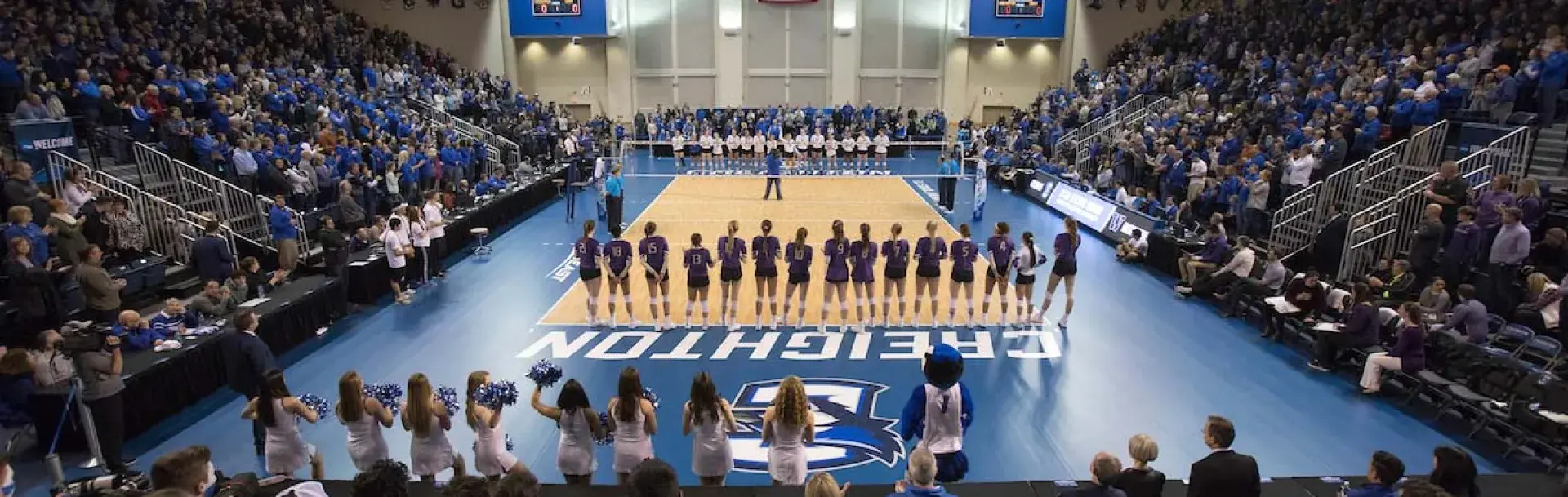 Bluejay volleyball game with teams and fans