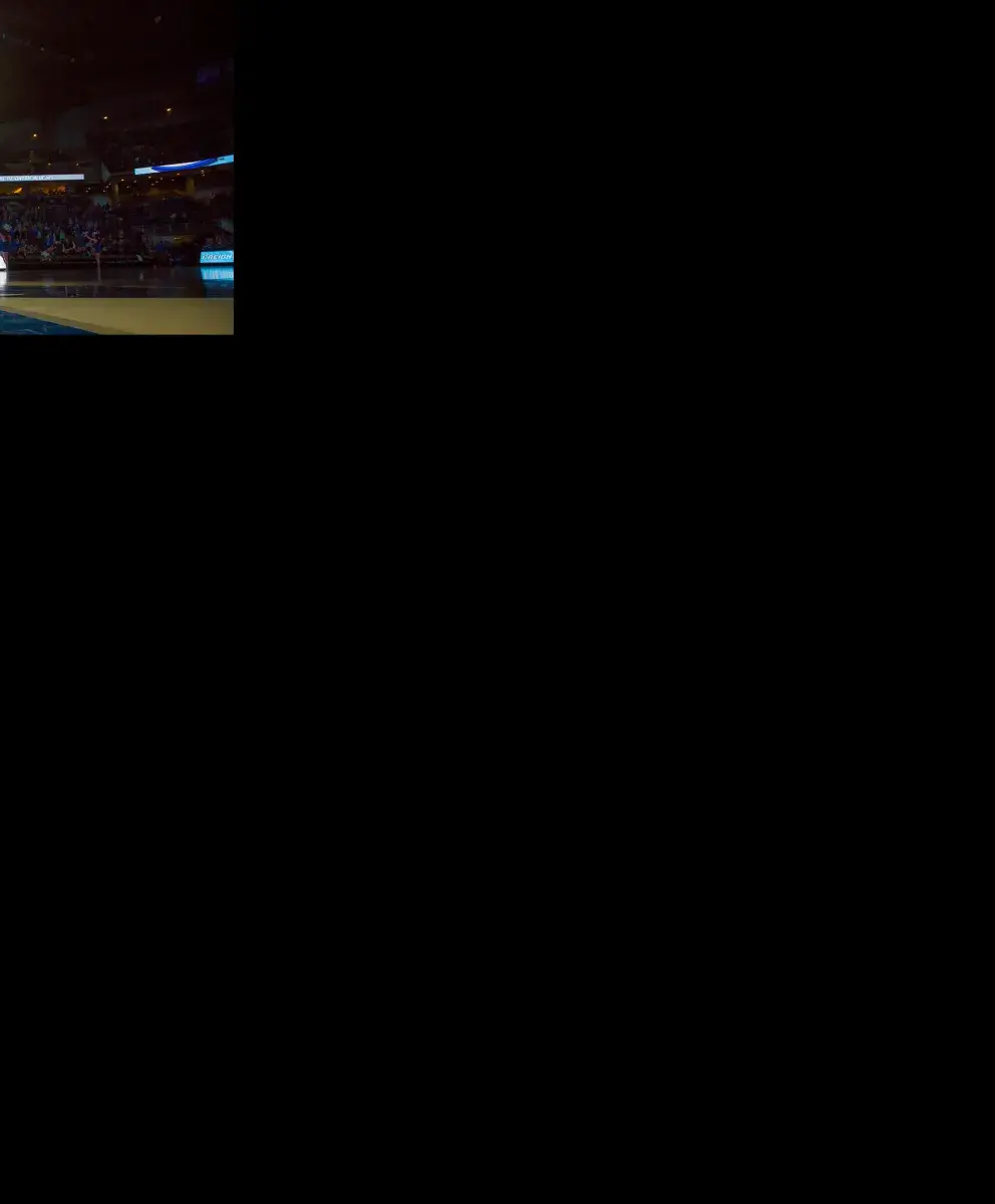 Billy Bluejay at Basketball Game with Flag