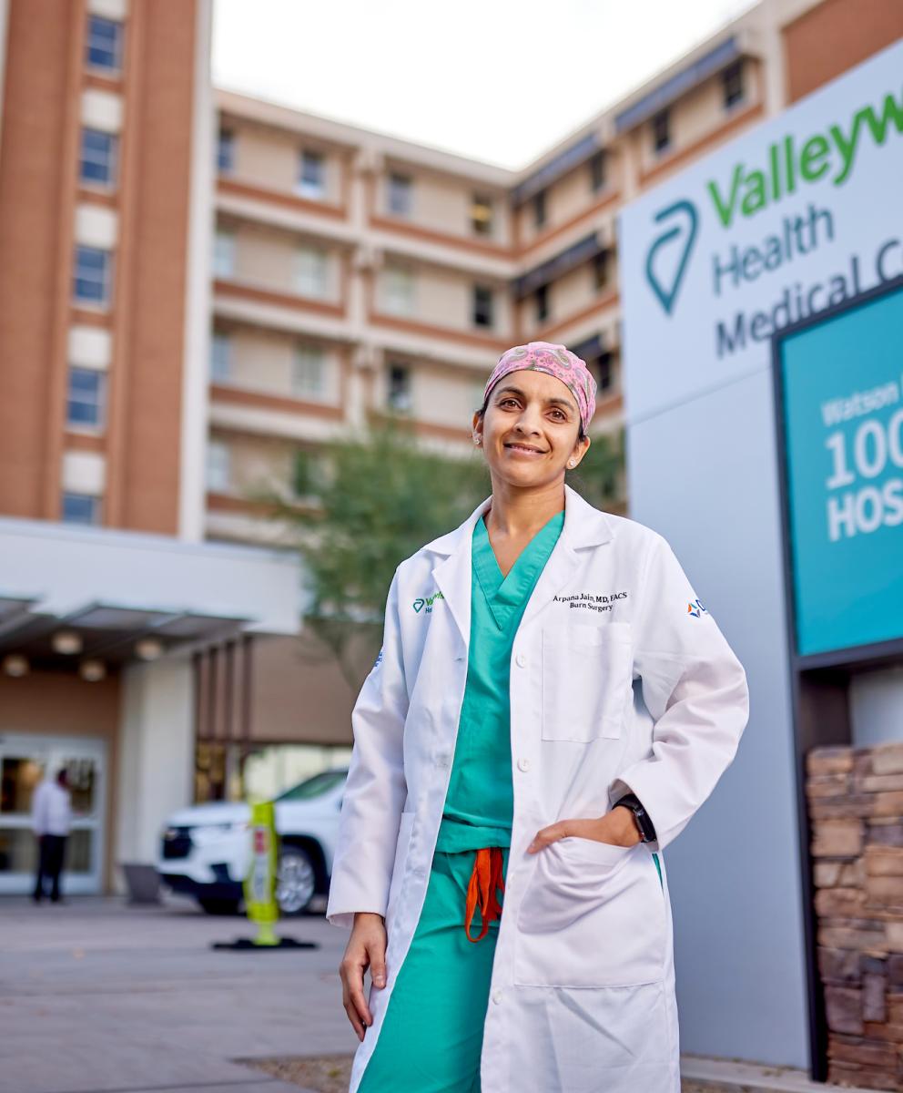 Doctor standing in front of Valleywise Health building