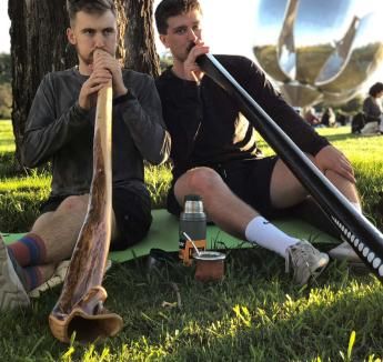 Students in study abroad program using didgeridoo