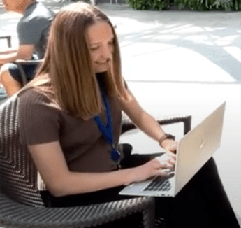 Meghan Baudendistel sitting outside with laptop