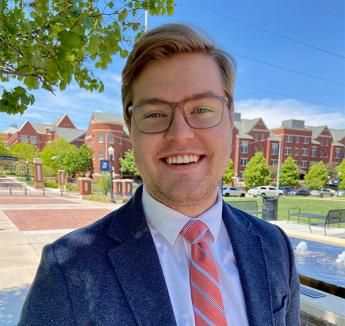 Isaac Westphal smiling outside on Creighton campus