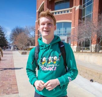 Tyler Langford on sunny day outside Heider College of Business.