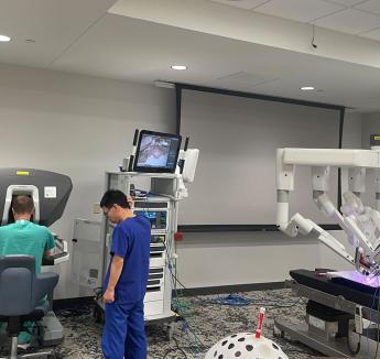 Students on machine at robotic surgery bootcamp