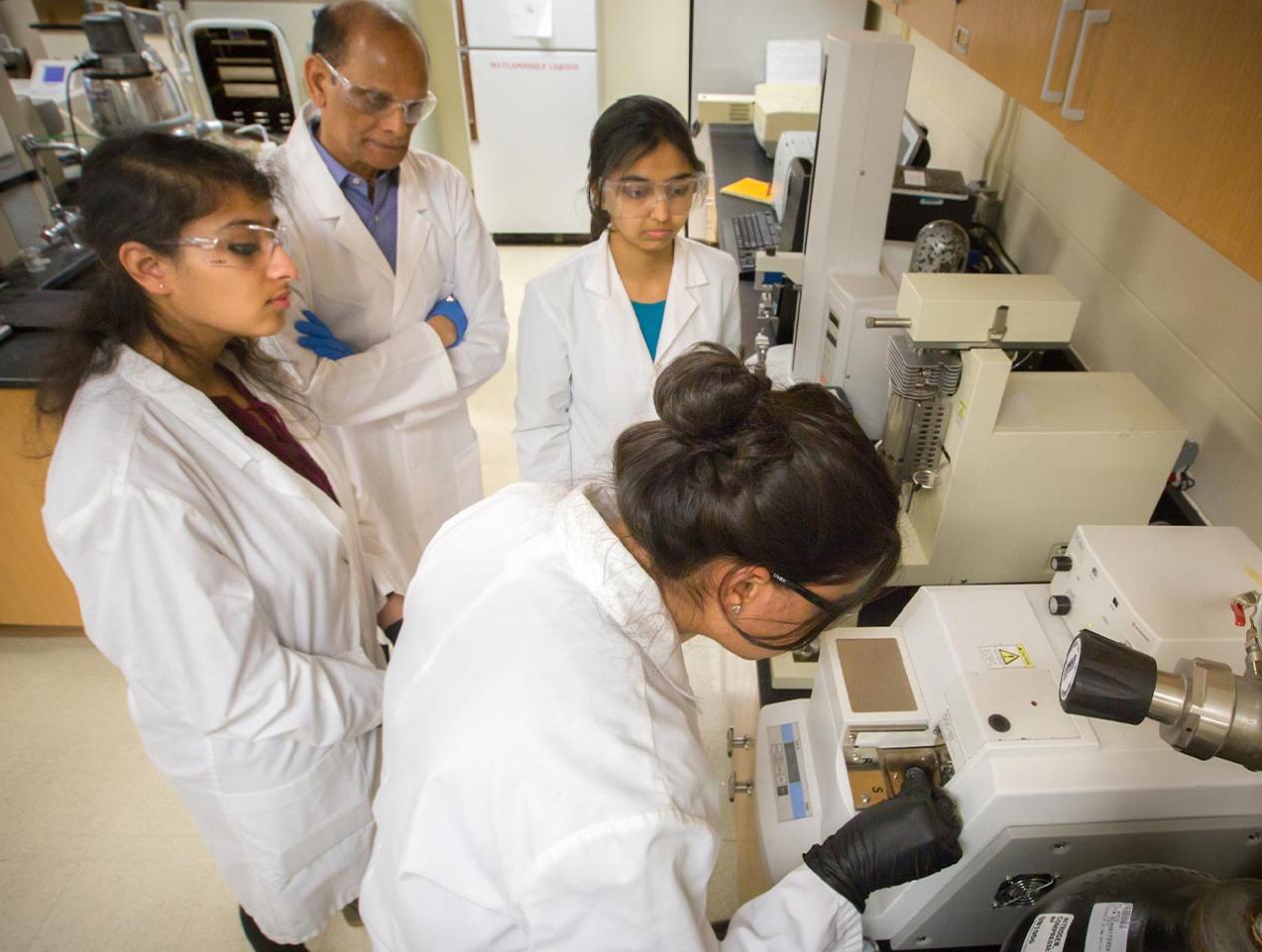 Dr. Alekha Dash with students in lab