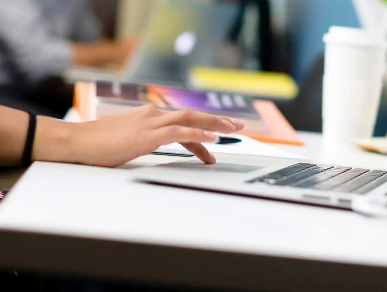 Student typing on laptop