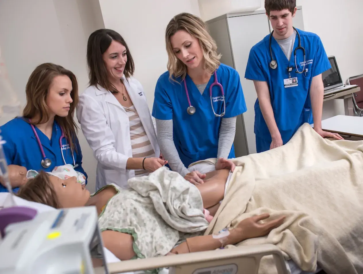 Joely Goodman with nursing students in simulation patient lab