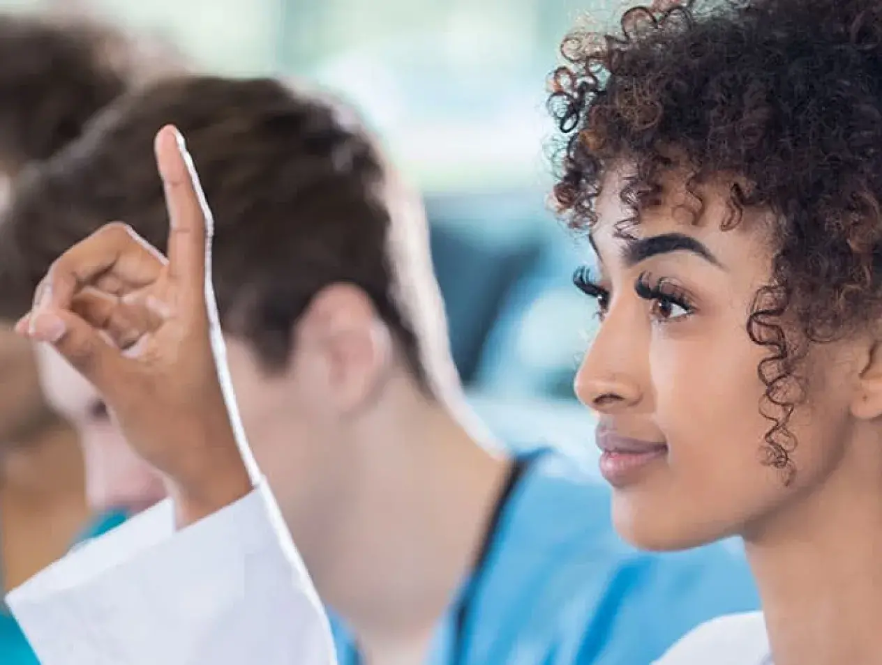 Student raising hand in class