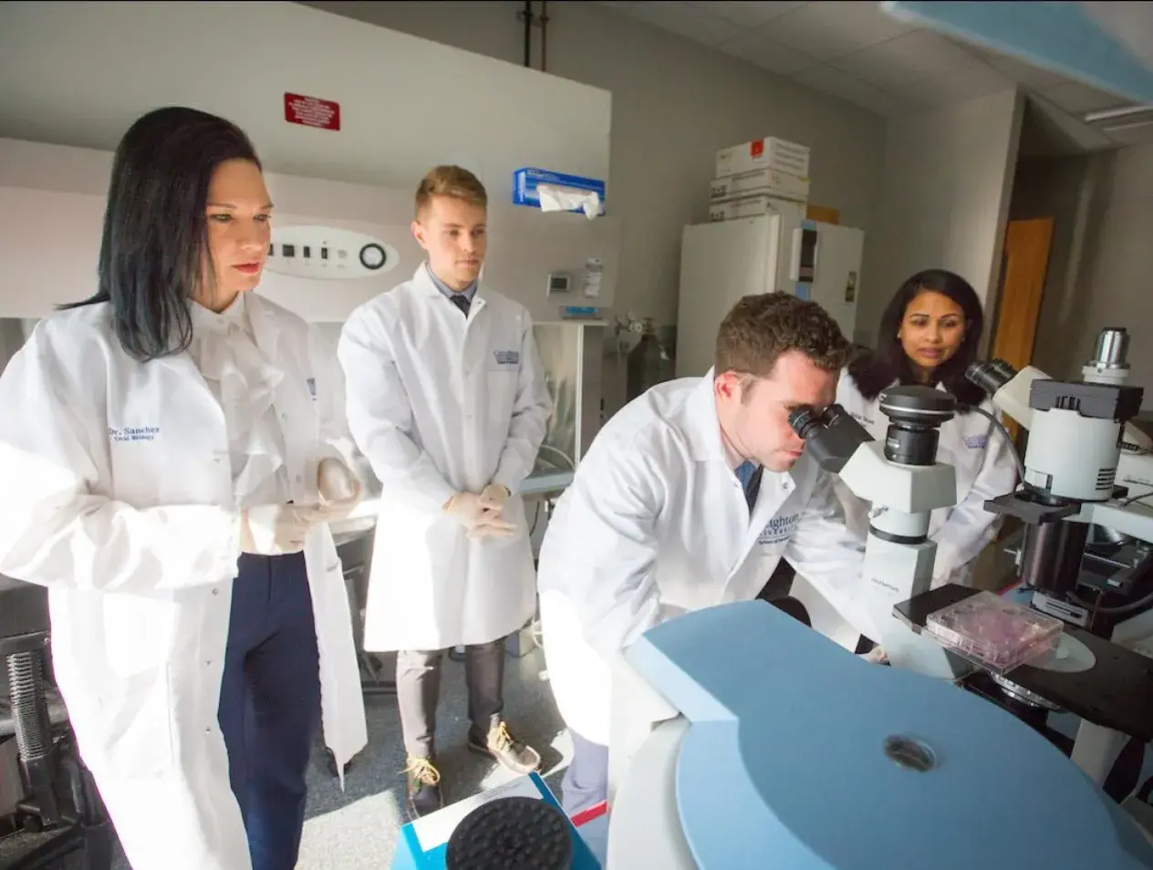 Dental students in lab setting with instructor