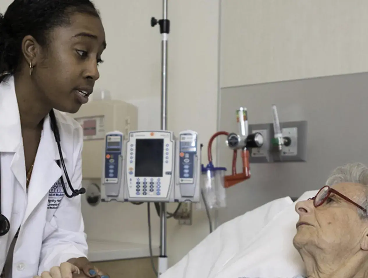 Doctor holding patients hand