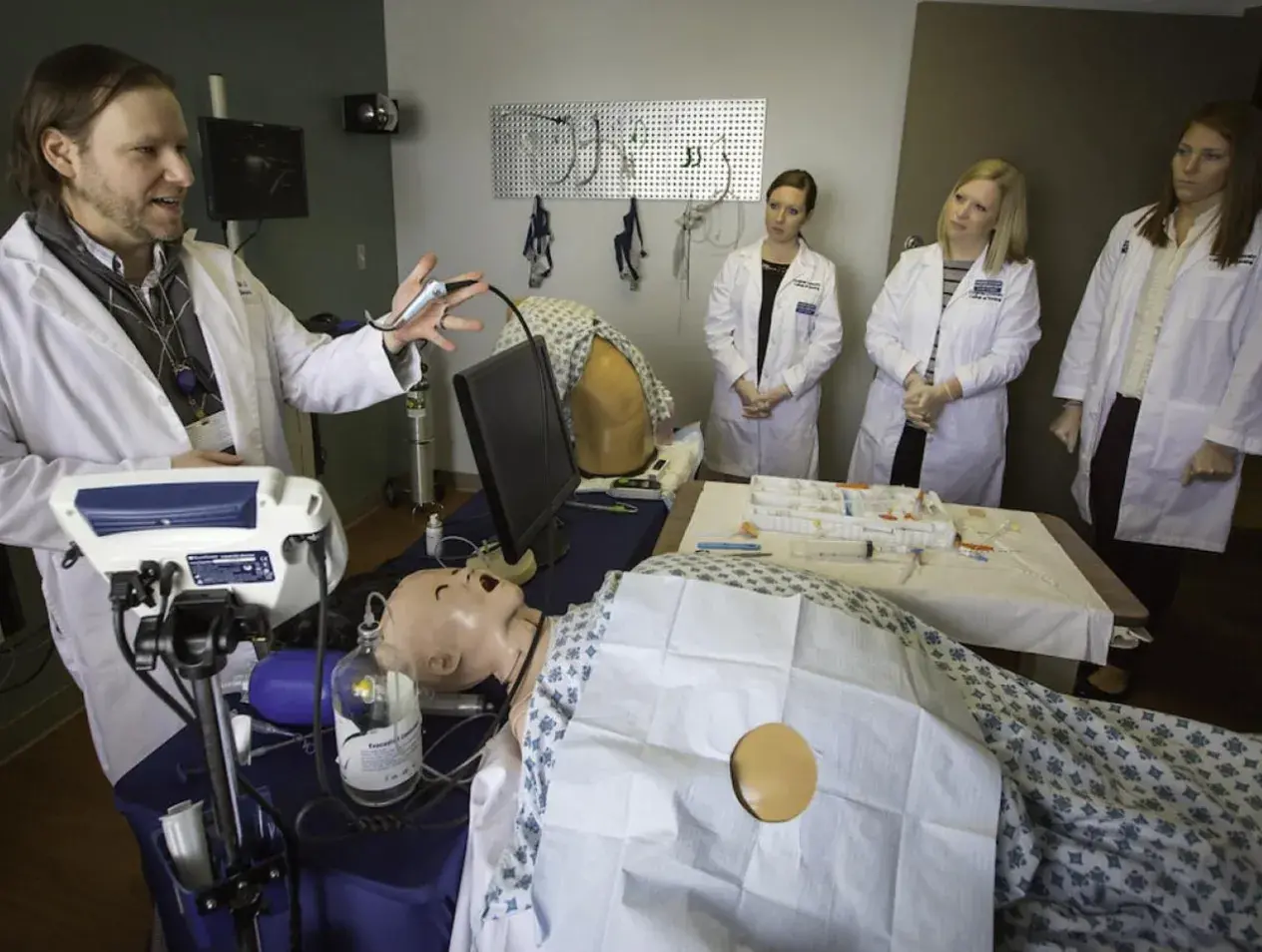 Nursing students receiving hands-on experience in simulation lab.