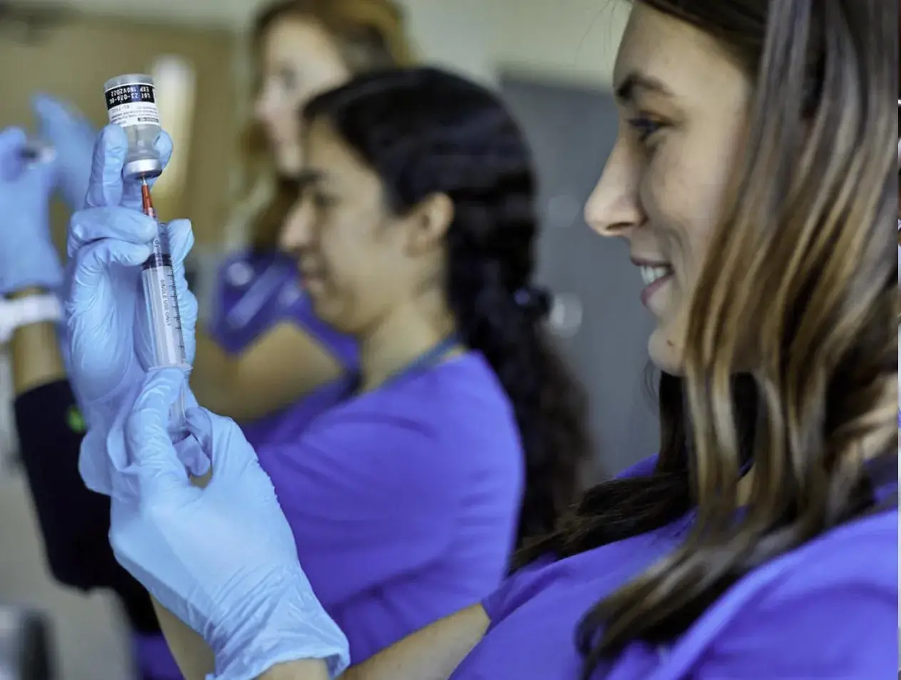 Nursing students practicing using hypodermic needles
