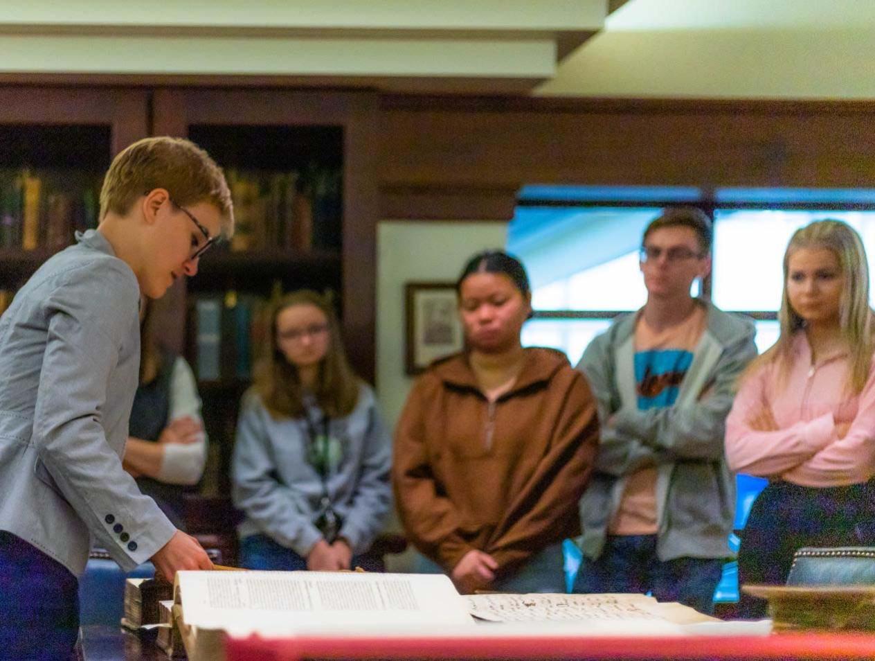 Dr. Ross shows students a rare book.