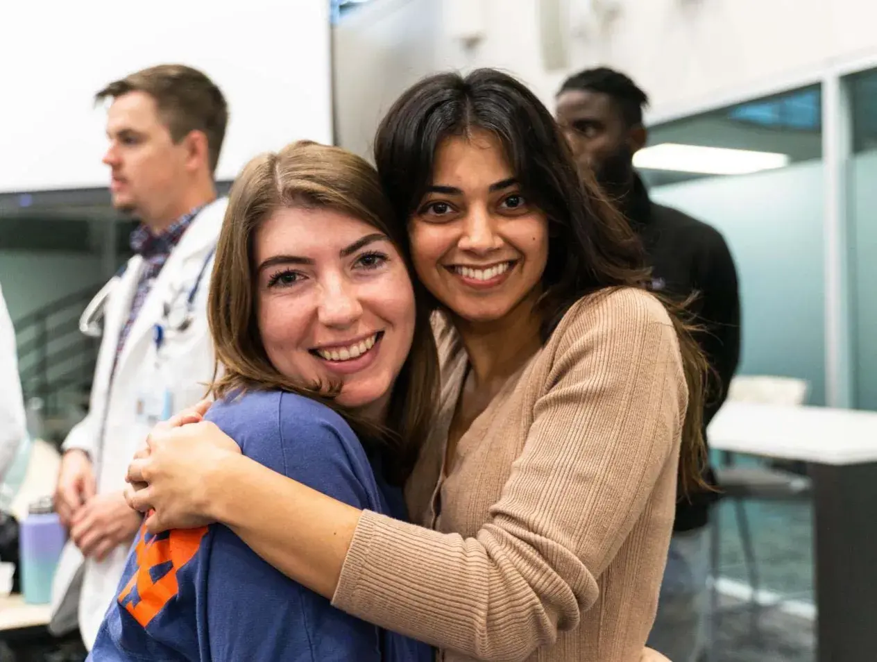 2 diverse girls hugging and posing for camera