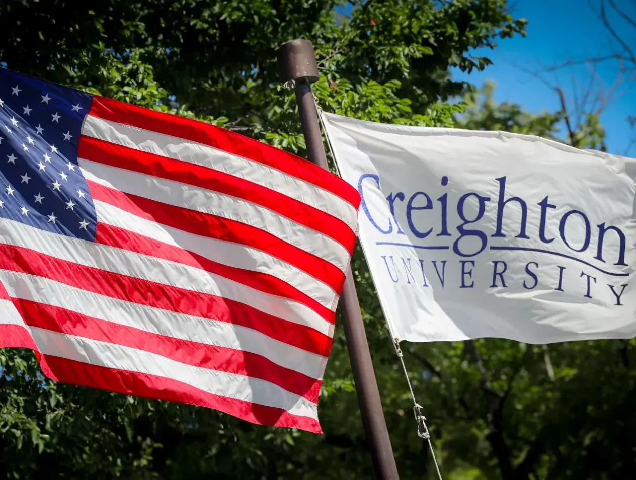 American flag next to Creighton University flag