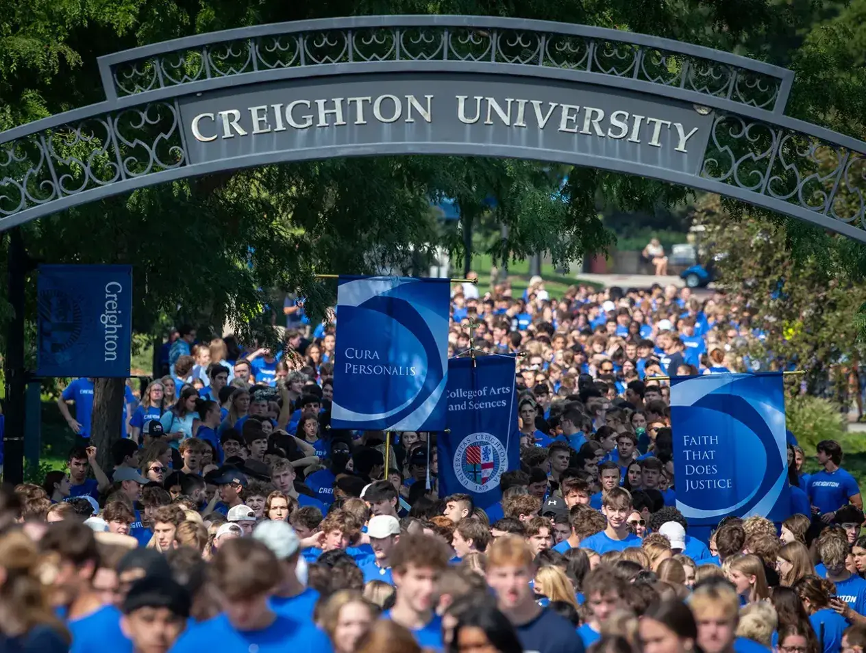 Students marching in mass down Creighton mall for convocation.