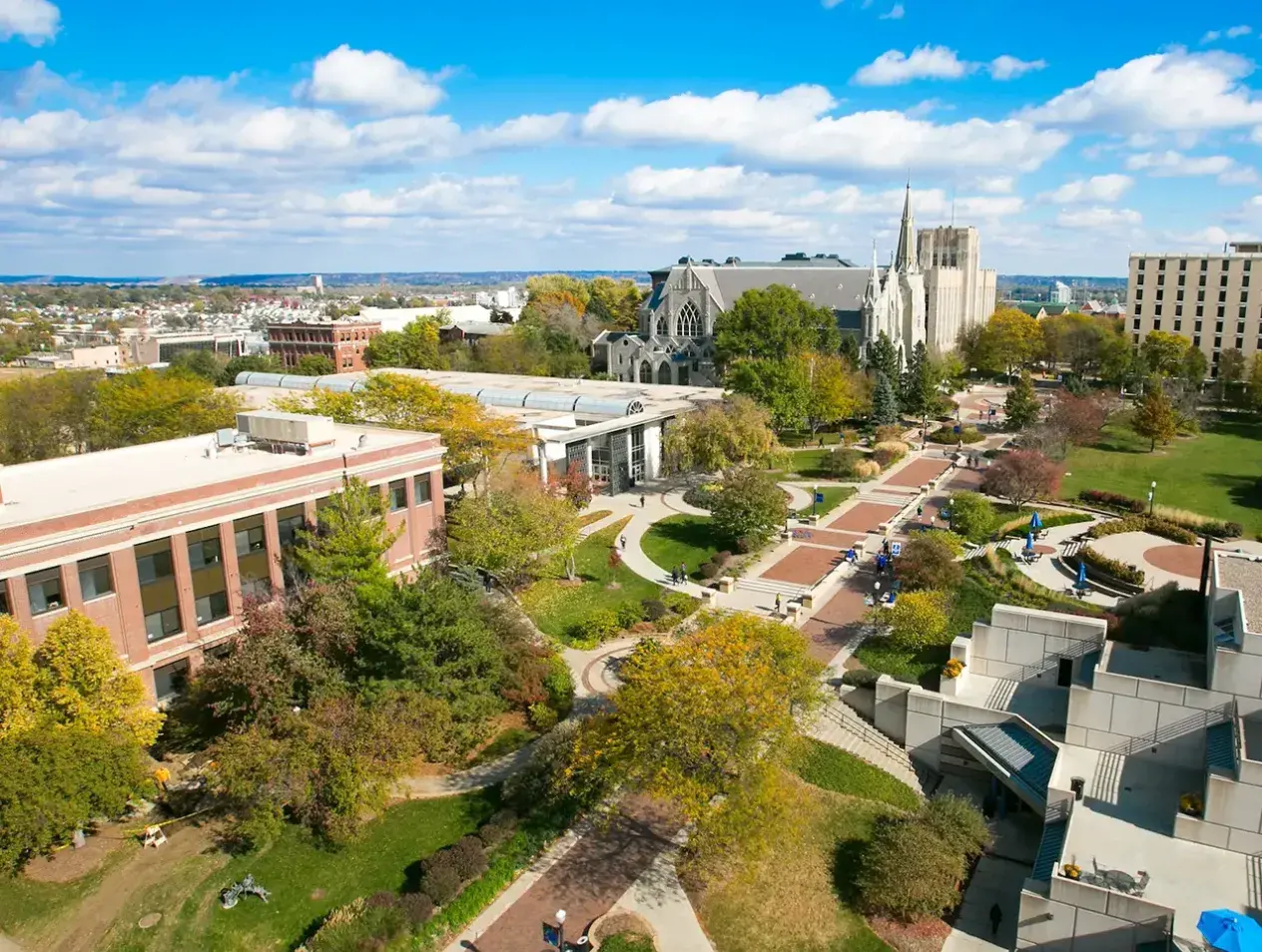 Drone shot of campus mall on cloudy summer day.