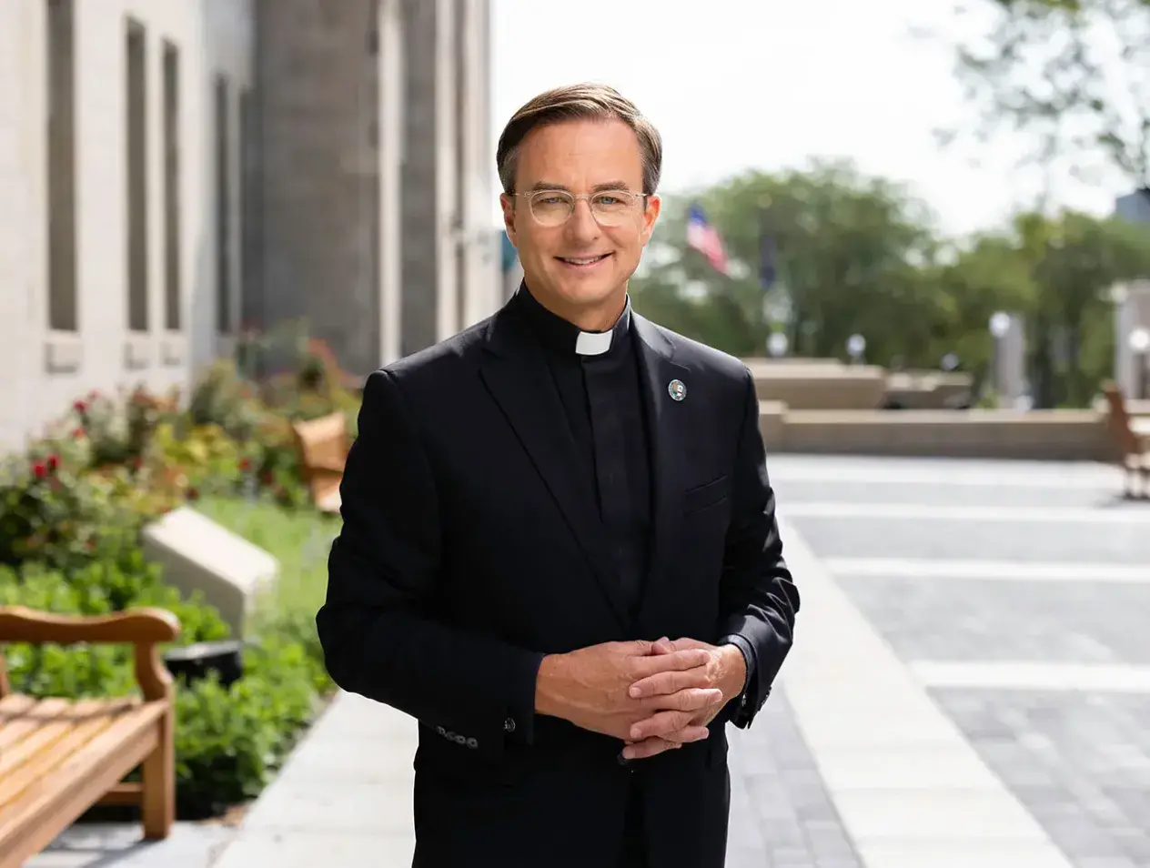 Father Hendrickson standing outside St. John's church.