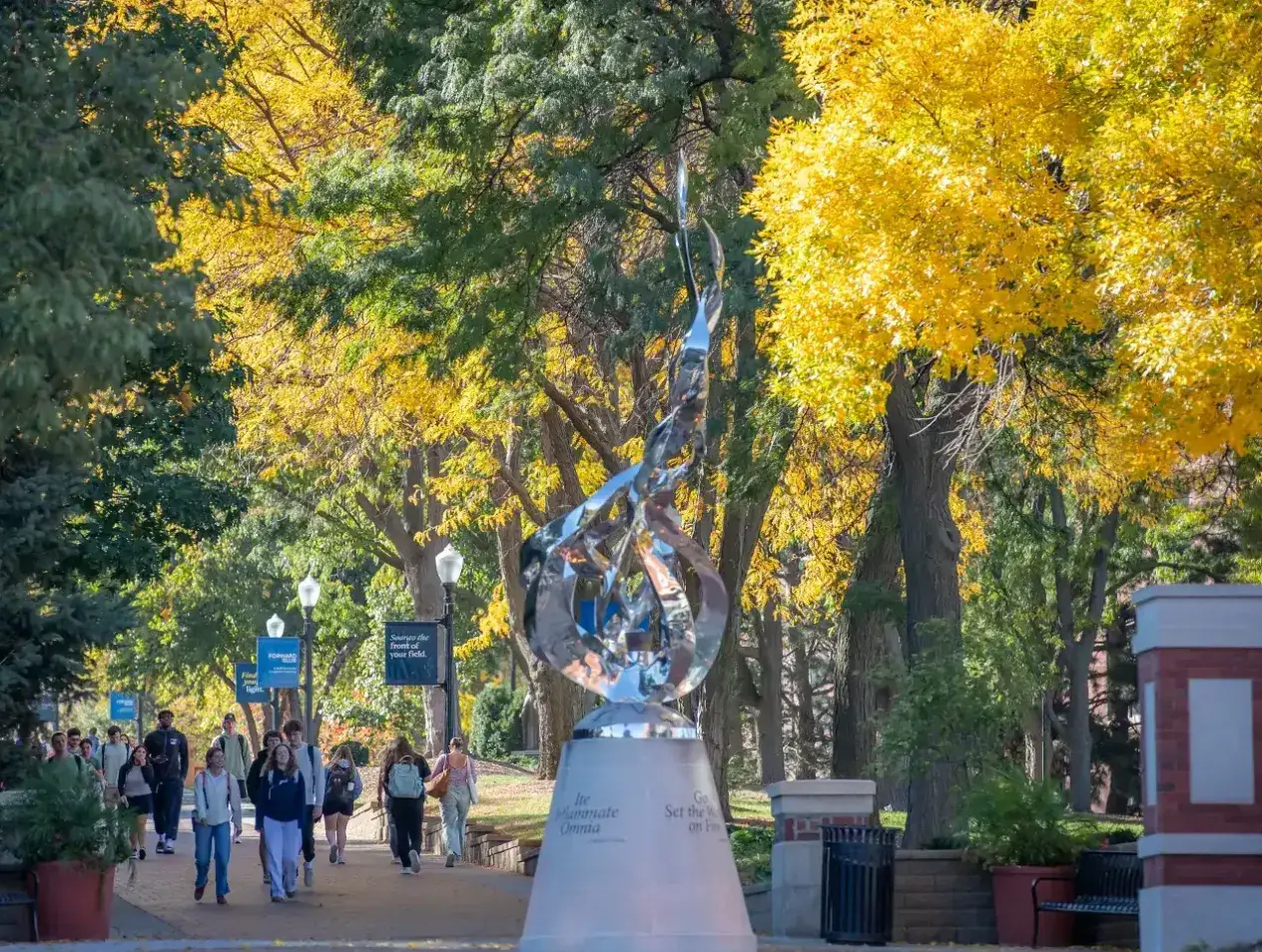 Sunny morning as students walk on Creighton mall.