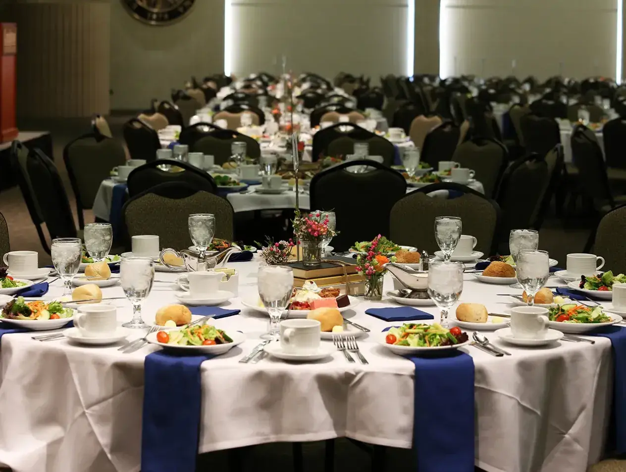Tables set for dinner at ballroom reception.