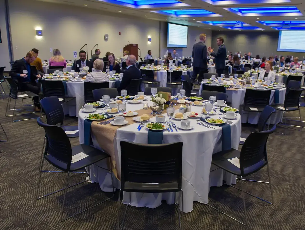 Elegant tables set for a dinner event.
