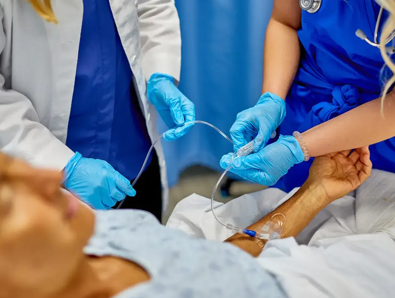 Students practicing nursing techniques in lab.