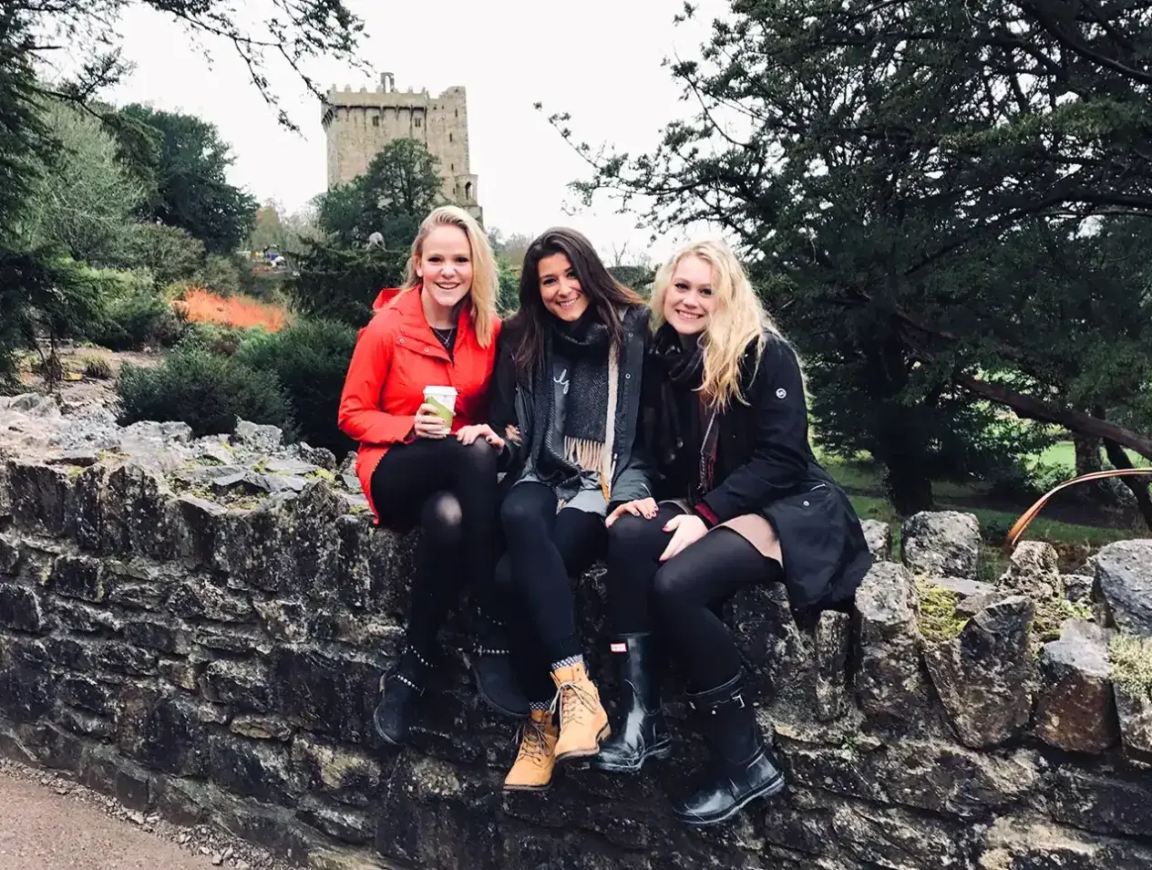 Creighton students posing on rock wall overseas.